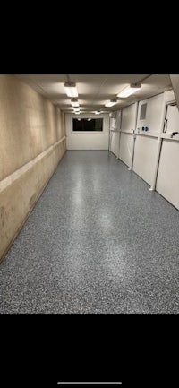 a garage with a white floor and black walls