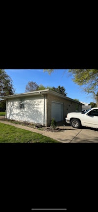 a white truck is parked in front of a house