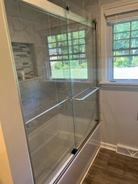 a bathroom with a glass shower door