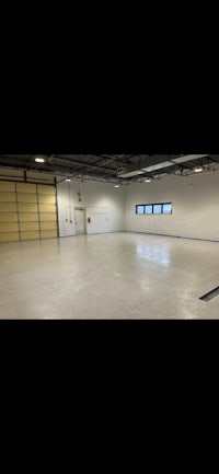 a large empty room with windows and a door