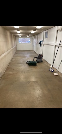 a garage with a broom and a mop