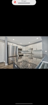 a photo of a kitchen with stainless steel appliances