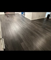 a living room with a black hardwood floor