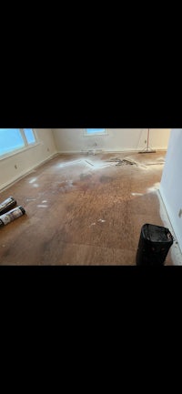 a room with a wooden floor being refinished