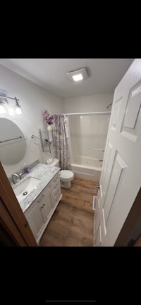 a white bathroom with a bathtub and sink