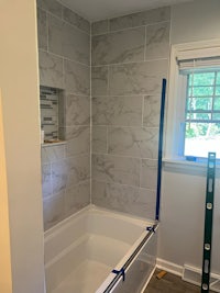 a bathroom is being remodeled with a tub and tile