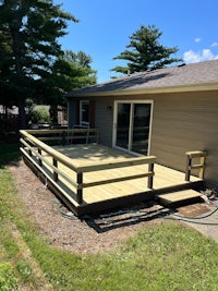 a wooden deck with a railing and a railing