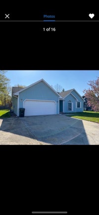 an image of a house with a garage and driveway